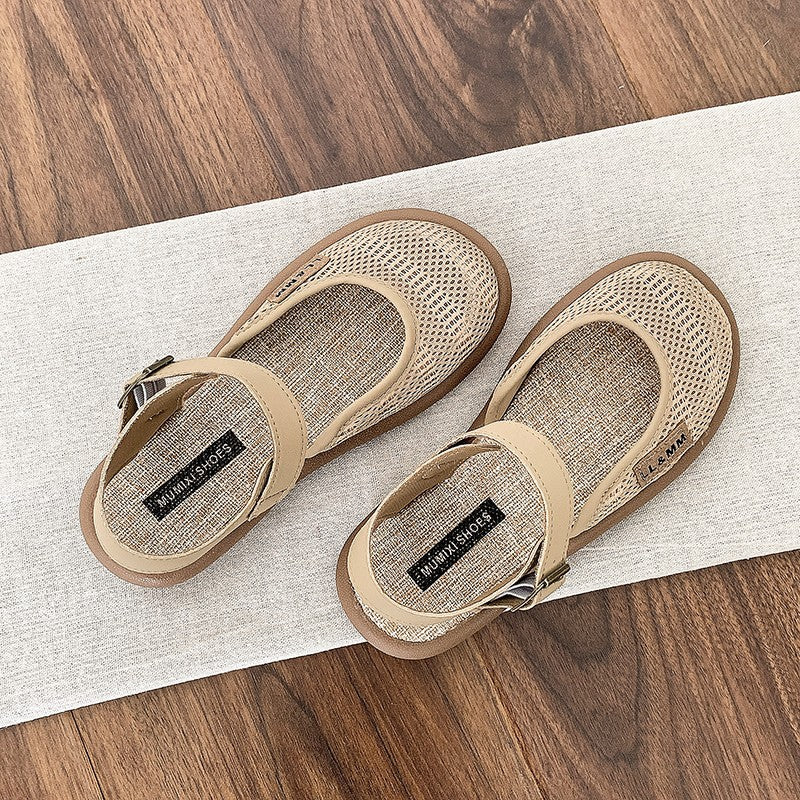 Pair of beige closed-toe flat sandals viewed from above