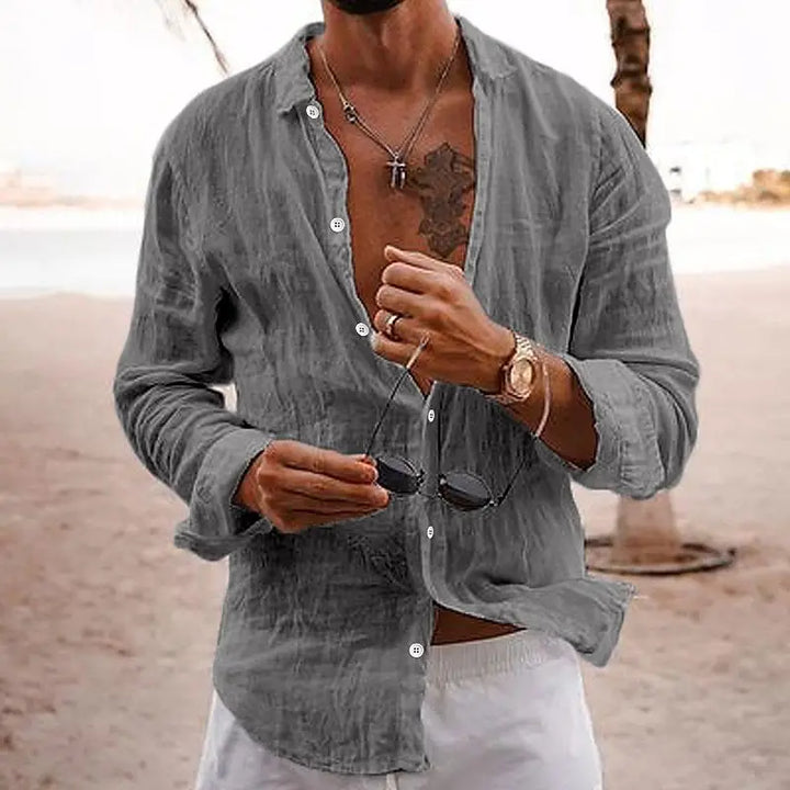 Man wearing grey long sleeve casual button-down shirt outdoors