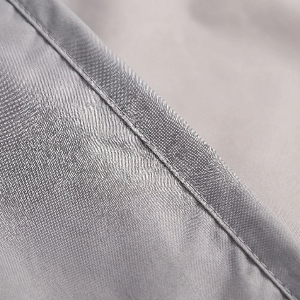 Compact camping sleep liner unfolded on grass during outdoor adventure