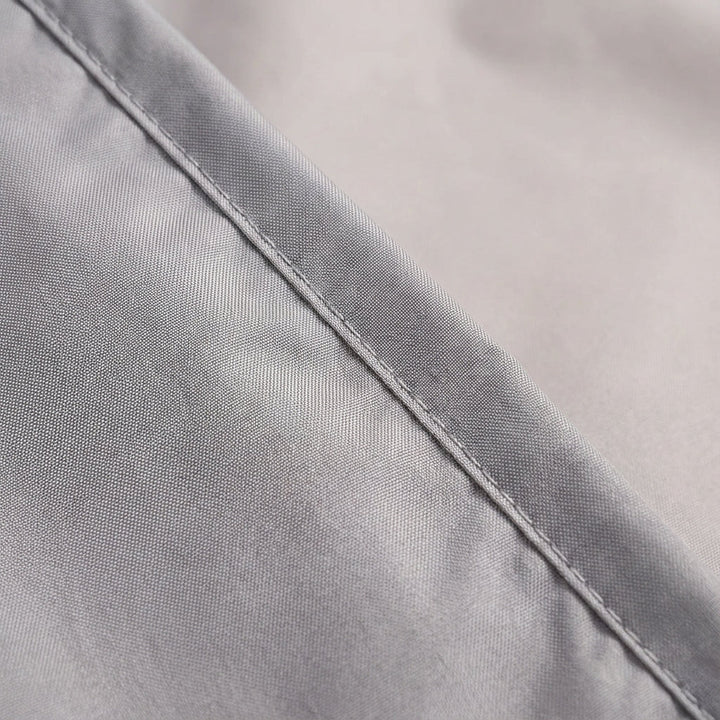 Compact camping sleep liner unfolded on grass during outdoor adventure