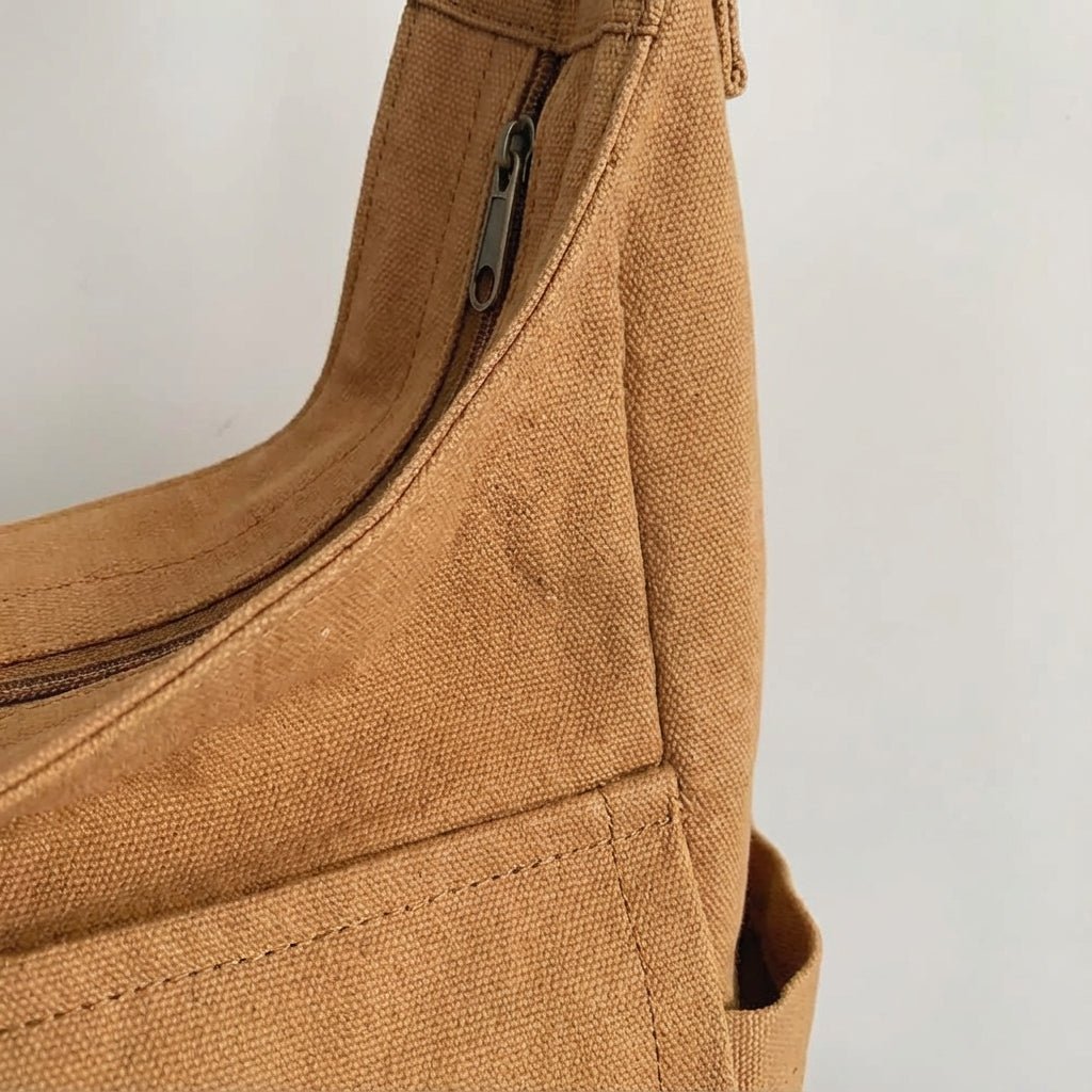 Open view of everyday carry canvas shoulder bag with interior storage pockets