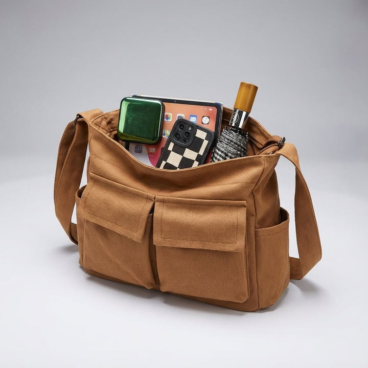 Side angle of casual canvas messenger bag showing adjustable crossbody strap