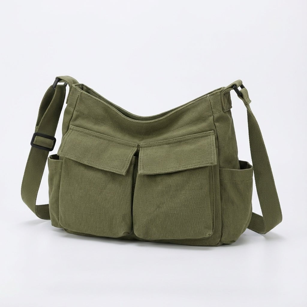 Unisex canvas shoulder bag worn styled as a casual crossbody bag