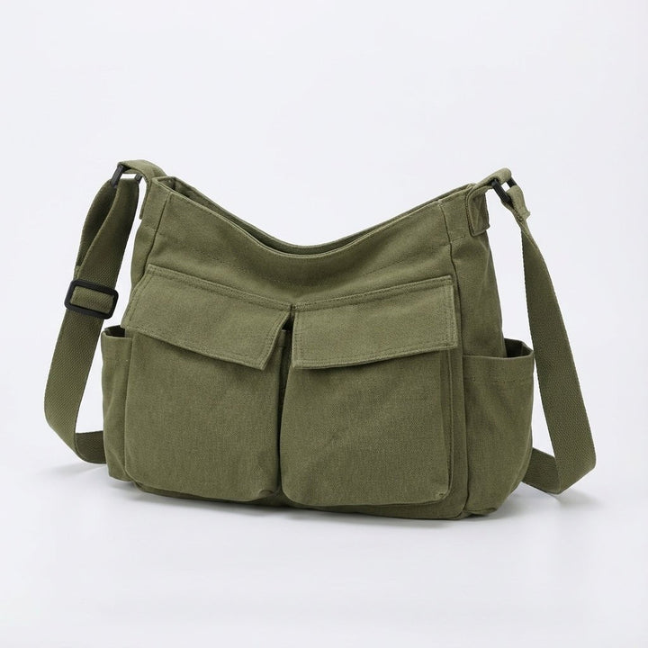 Unisex canvas shoulder bag worn styled as a casual crossbody bag
