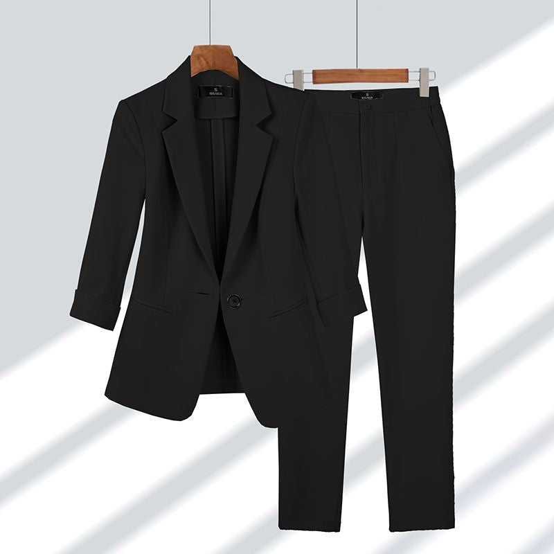 Black women's two-piece suit hanging on display