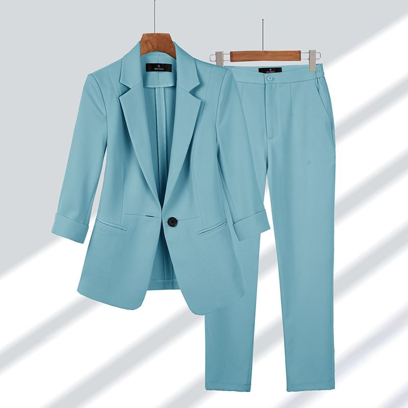 Light blue women's two-piece suit on a hanger
