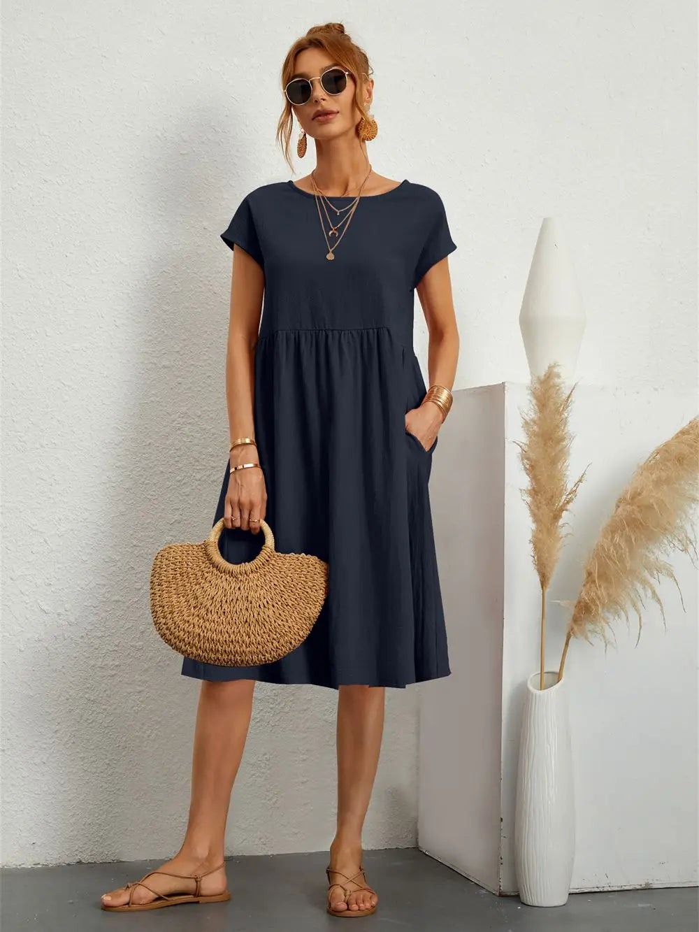 Fabric texture and swing hemline detail of the a-line midi dress