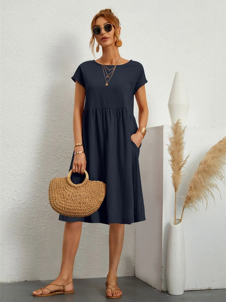 Women's casual a-line midi dress showcasing deep functional side pockets