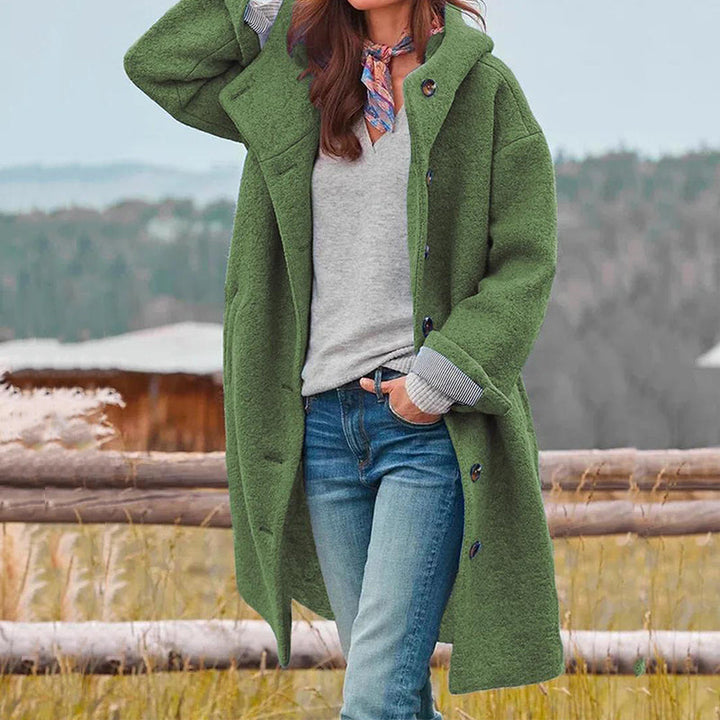 Woman wearing the green Aria casual long hooded coat outdoors