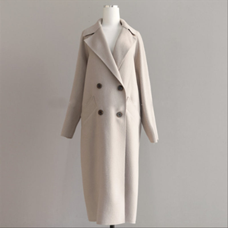 Side profile view of the beige women's long winter coat showcasing the casual wool jacket design.