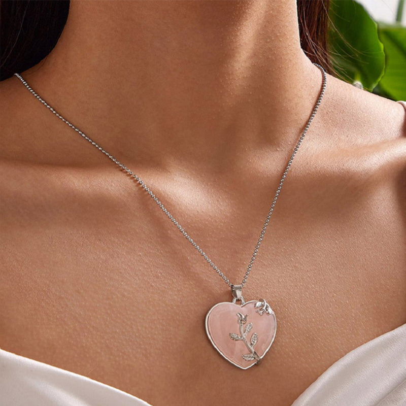 A model wearing the Rose Quartz heart pendant necklace against a neutral outfit.