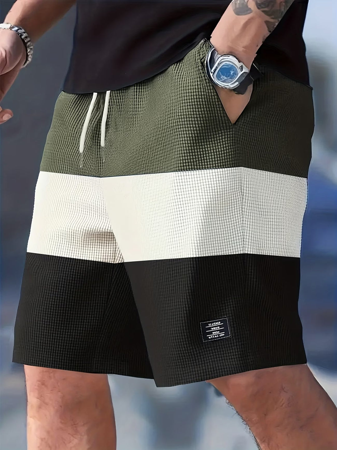 Man wearing green textured casual summer shorts in outdoor setting