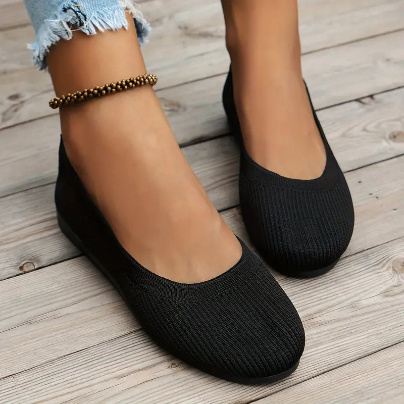 Close-up of women's black non-slip casual flats showcasing textured stretch upper design.