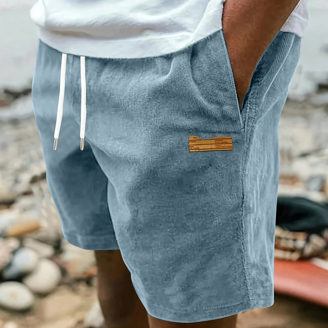 Lifestyle shot of man wearing relaxed fit summer shorts outdoors