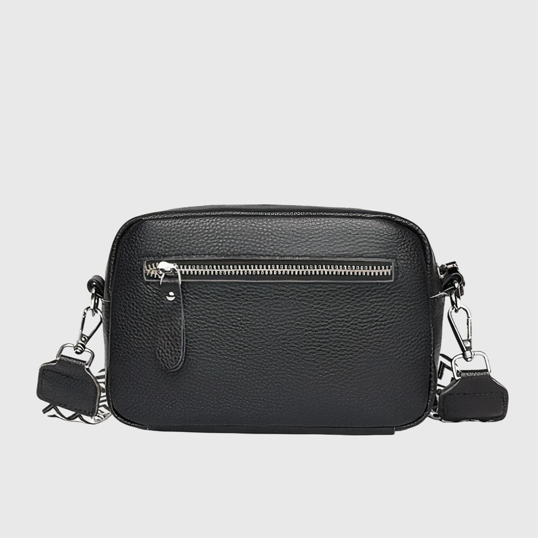 Rear view of the black crossbody bag showing the practical exterior zipper pocket