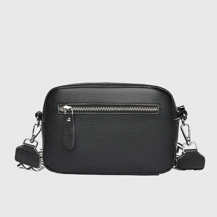 Rear view of the black crossbody bag showing the practical exterior zipper pocket