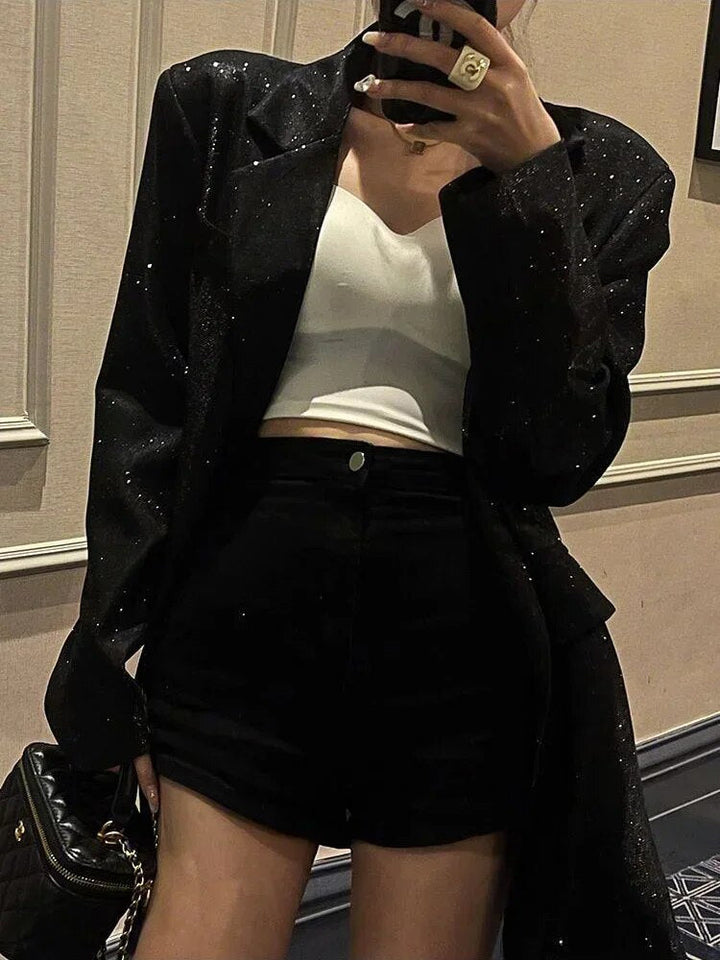 Close up fabric detail of womens holiday style sequin blazer outerwear