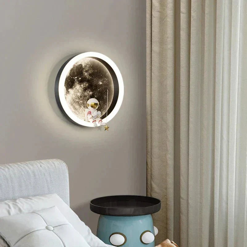 Black body moon wall lamp mounted above a bedside table with warm ambient glow
