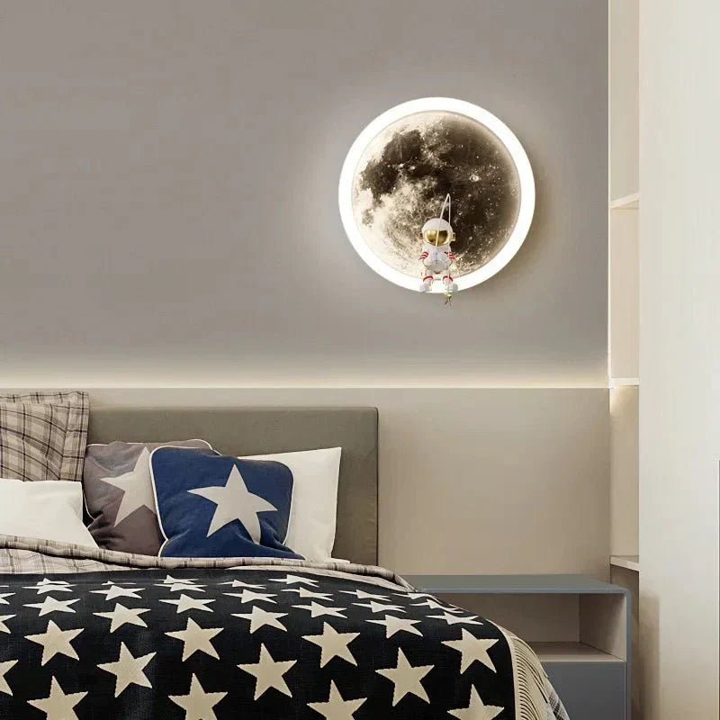 White body moon wall lamp glowing softly above a modern child's bedroom bed
