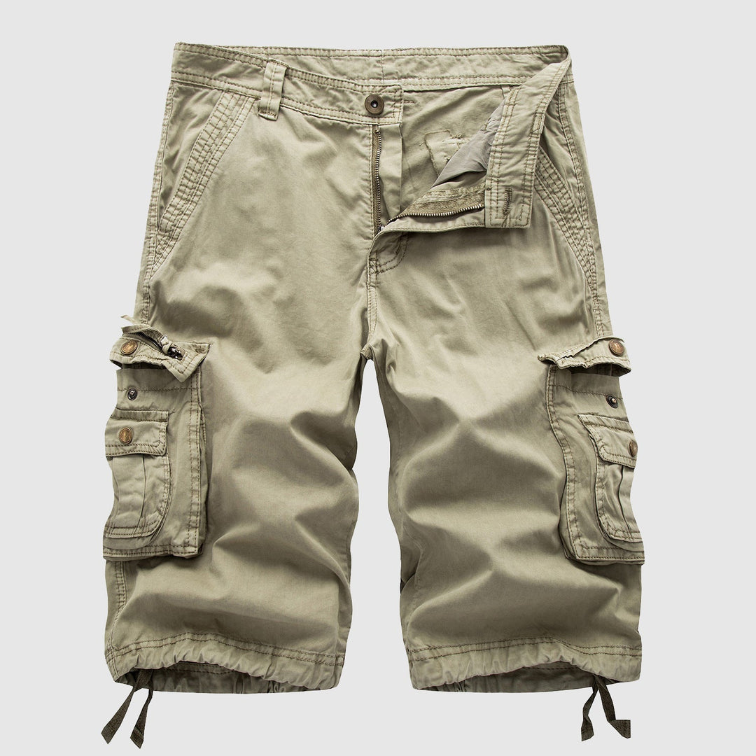 Men's beige cargo knee length shorts laid flat showing multiple side pockets and button closure