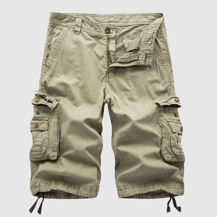 Men's beige cargo knee length shorts laid flat showing multiple side pockets and button closure