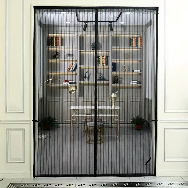 Full view of black magnetic mesh screen door hanging in a doorway