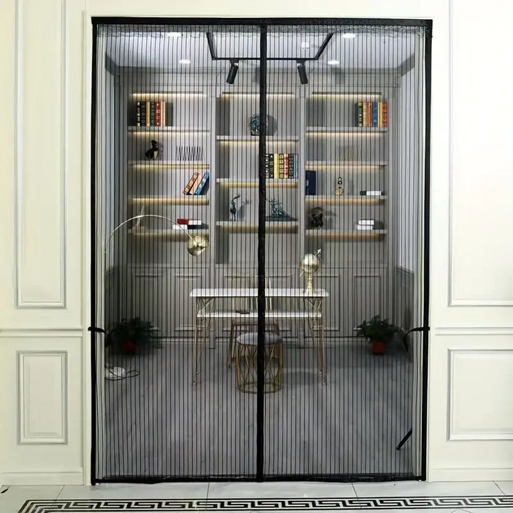 Full view of black magnetic mesh screen door hanging in a doorway