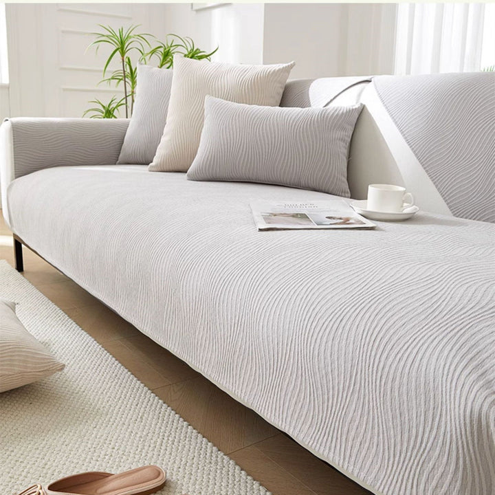 Close up view of the light gray textured sofa cover in a bright living room