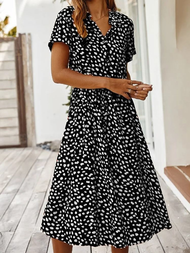 Back angle of model in comfortable short-sleeve printed midi dress