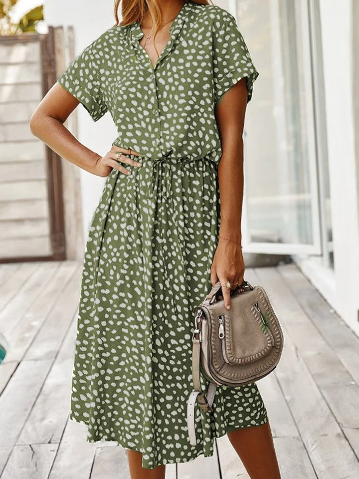 Model wearing green printed short-sleeve summer dress outdoors