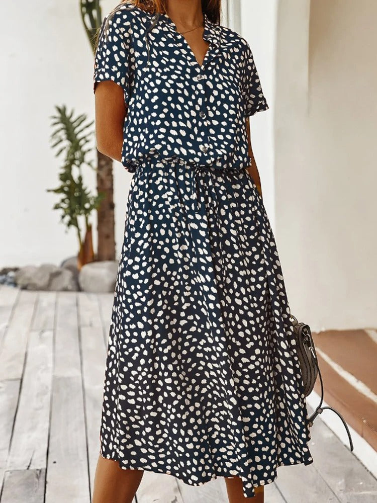 Lifestyle shot of woman in casual printed midi dress outdoors