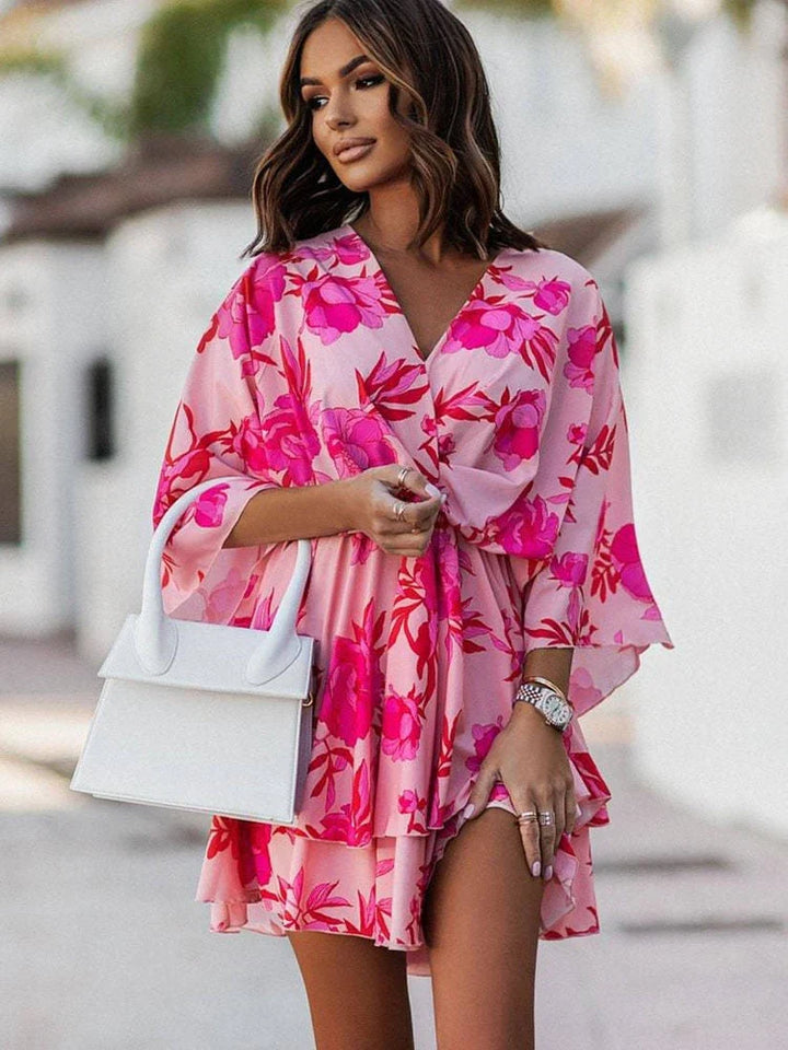Back view of the chic floral mini dress showing the flattering womens fit