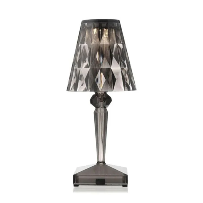 Chic crystal table lamp casting warm mood lighting on a nightstand
