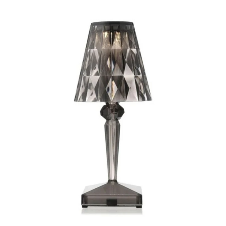 Chic crystal table lamp casting warm mood lighting on a nightstand