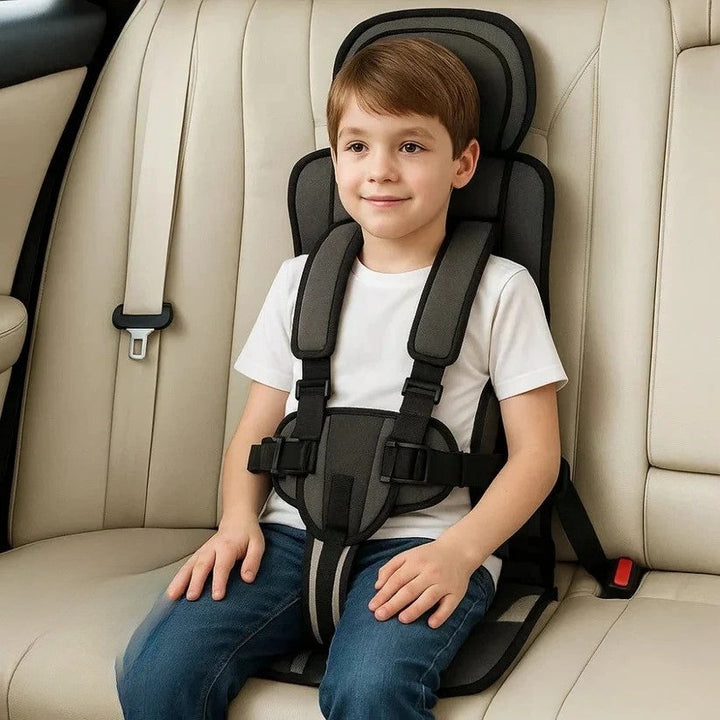 Portable foldable child car seat showing five point safety harness system
