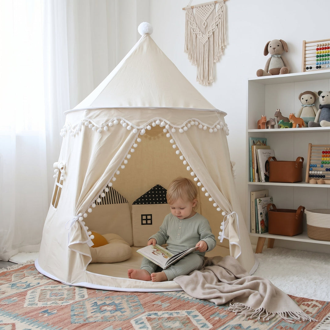 Toddler reading a book inside a light beige canvas play teepee in a bright living room