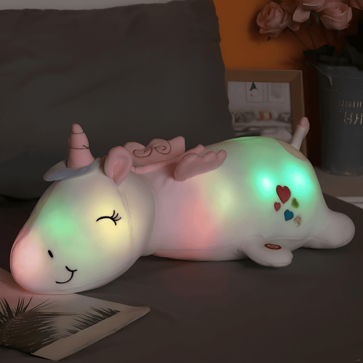 Unicorn plush night light glowing softly on a child bedside table for nursery decor