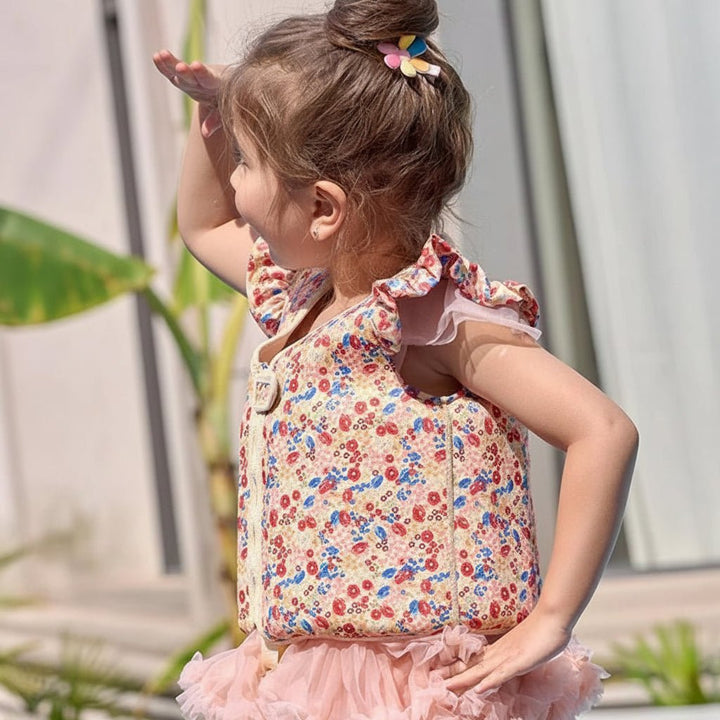 Flat lay of kids floatation gear and pool safety vest ready for summer fun