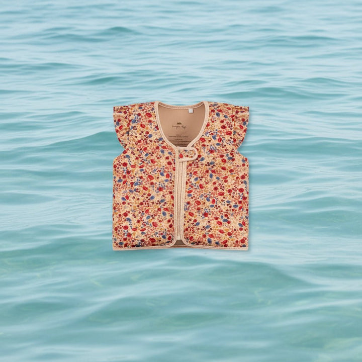 Children's floral print swim vest floating on water surface