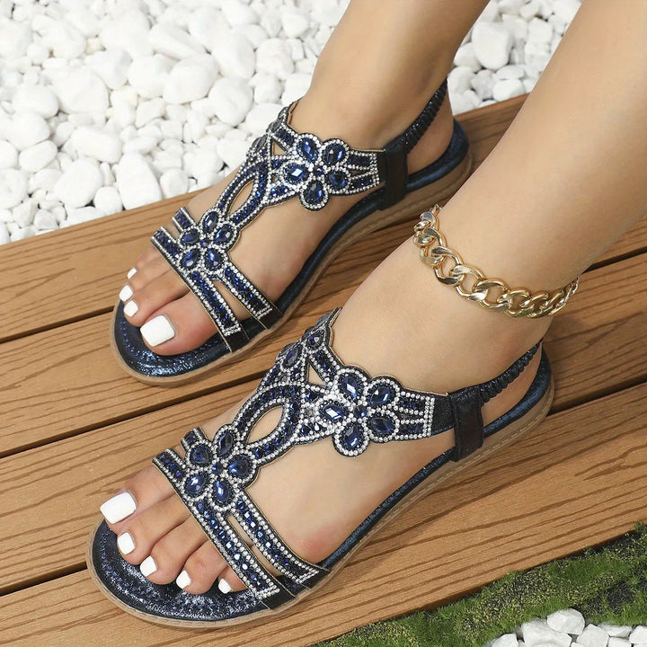 Packaging and presentation view of floral embellished footwear items