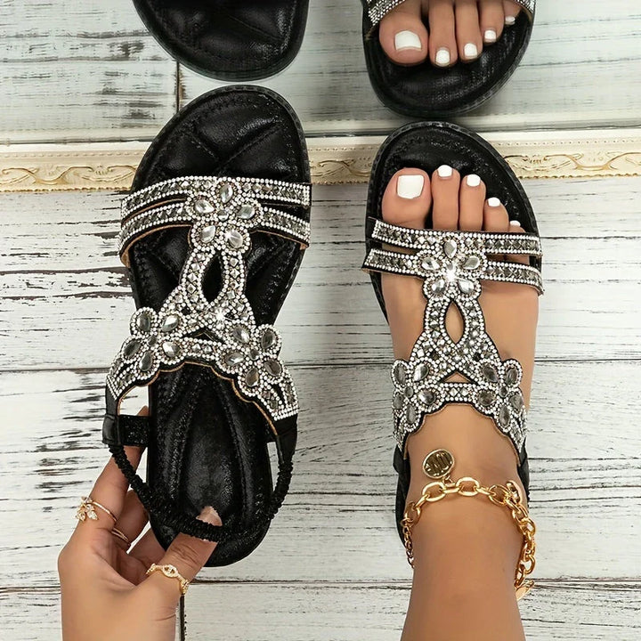 Side profile of comfortable flat sandals adorned with crystals and flowers