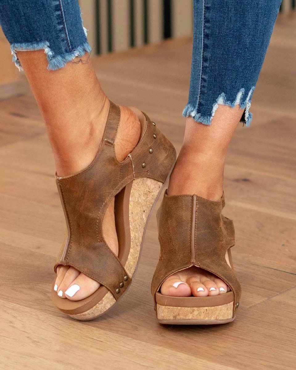Brown chunky wedge platform sandals worn with blue jeans