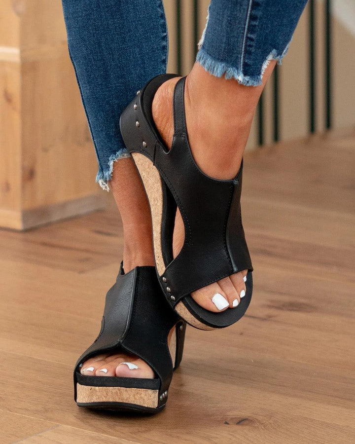 Angle shot of stylish women's wedge sandals paired with summer footwear style