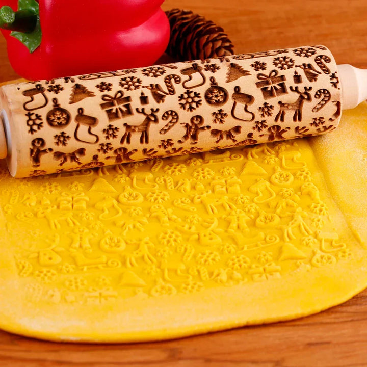 Wooden Christmas embossed rolling pin showing intricate festive holiday baking patterns