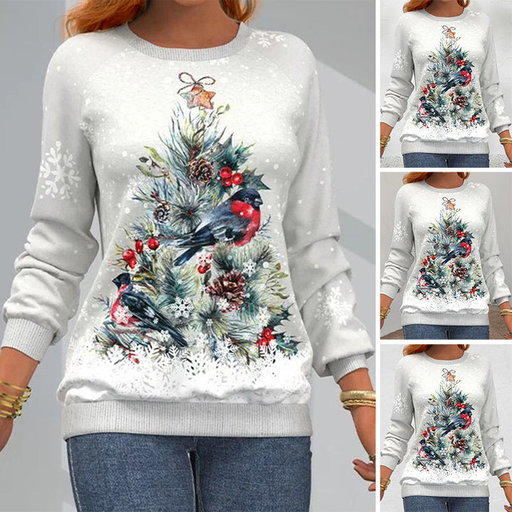 Close-up view of the Christmas tree and bird graphic print on the sweatshirt