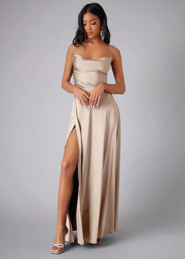 Model wearing beige satin maxi gown with high slit