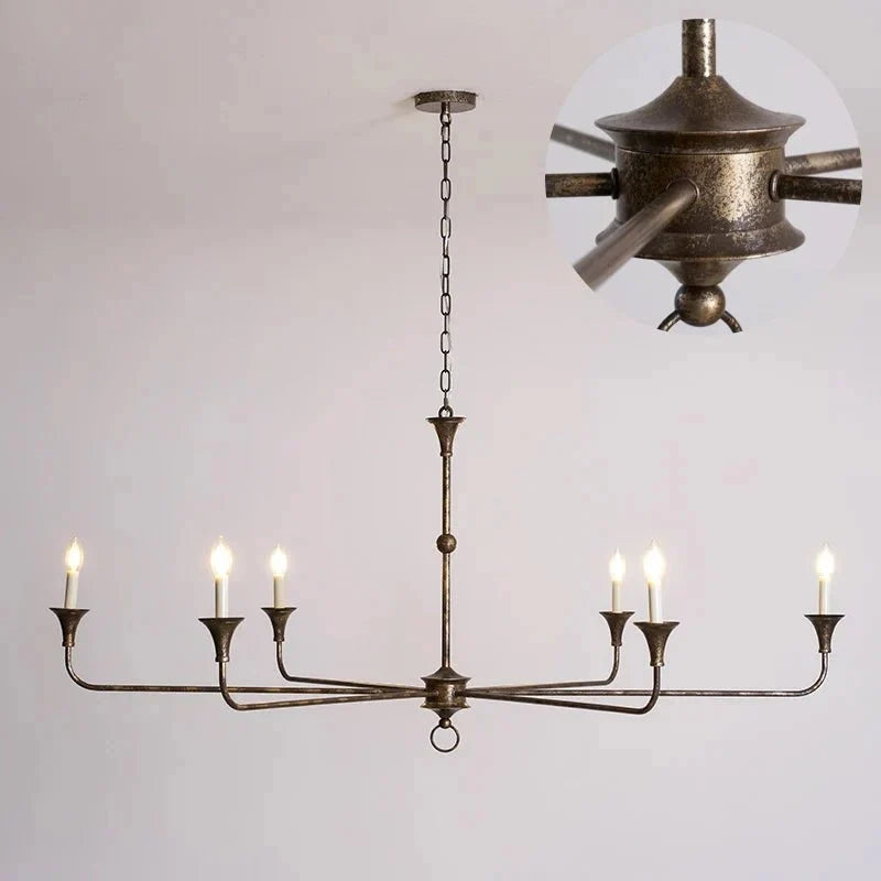 Wide six-light antique finish chandelier showing detailed central fixture arms