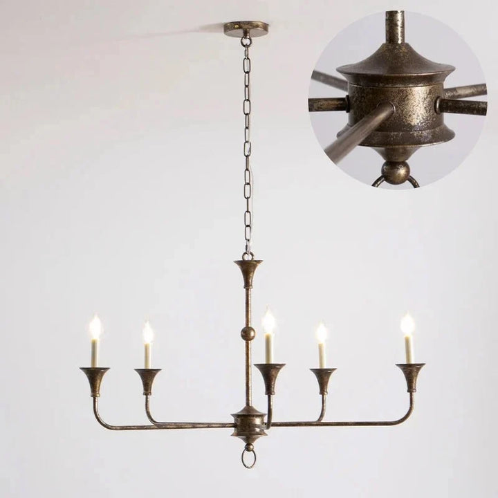Classic brass chandelier light installed with a candle-style design and hanging chain