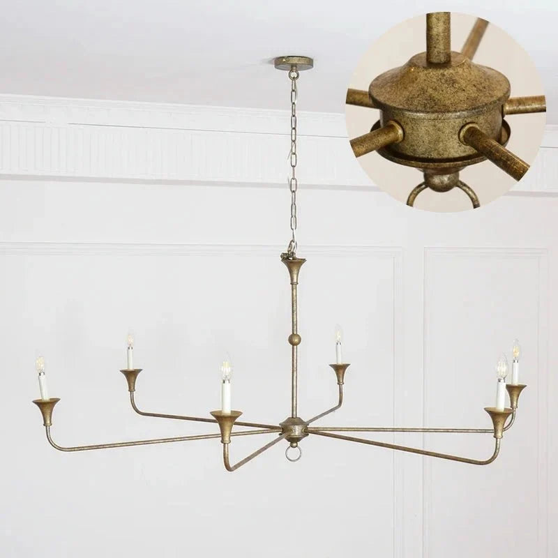 Gold leaf finish classic chandelier mounted on a ceiling with warm lighting