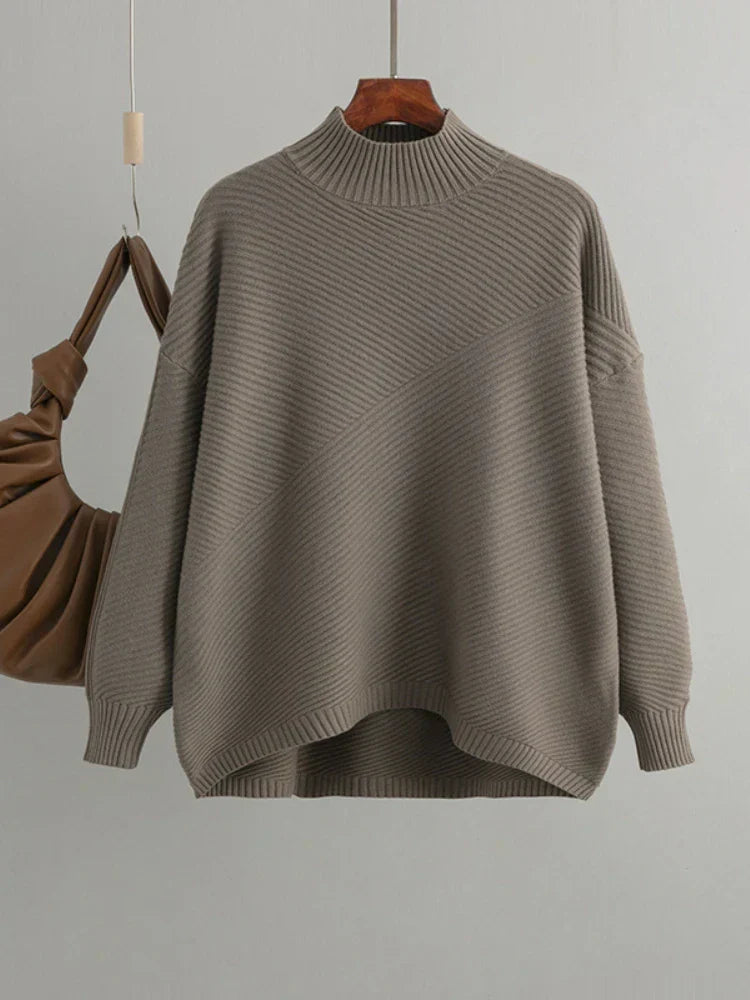 Women's classic light brown ribbed knit jumper hanging against a neutral background